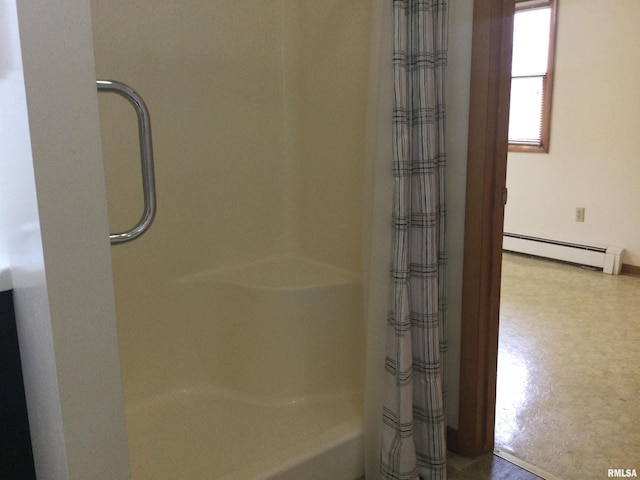 bathroom with baseboard heating and walk in shower