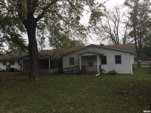 view of front of house with a front lawn and a sunroom