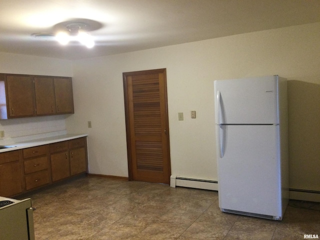 kitchen with a baseboard radiator and white appliances