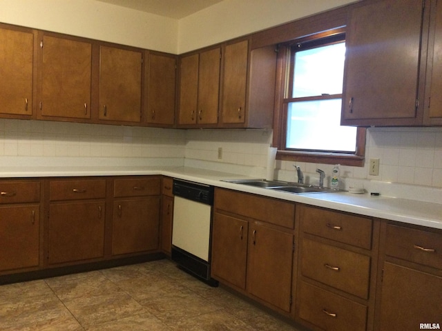 kitchen with white dishwasher, sink, and decorative backsplash