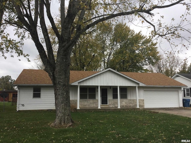 ranch-style house featuring a front yard, a porch, and a garage