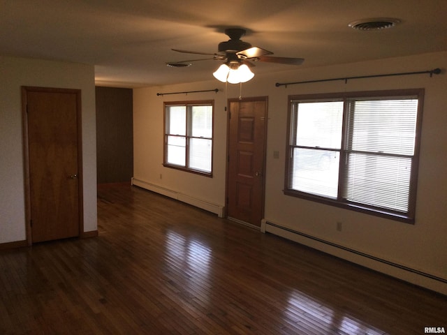 spare room featuring baseboard heating, dark wood-type flooring, and ceiling fan