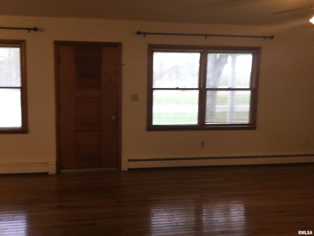 spare room with a baseboard radiator, dark hardwood / wood-style floors, and ceiling fan