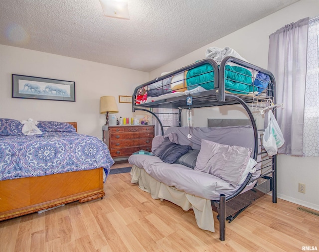 2857 State Route 161st Hwy, Centralia, IL 62801 - bedroom featuring wood finished floors, a textured ceiling, and baseboards