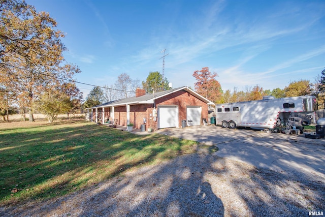 view of side of home featuring a garage and a yard