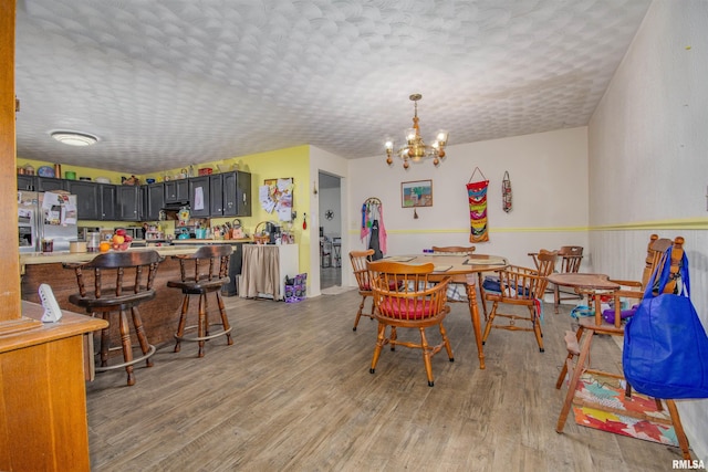 2857 State Route 161st Hwy, Centralia, IL 62801 - dining area featuring light wood-style flooring, a textured ceiling, and a chandelier