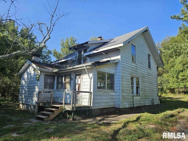 back of house with a lawn