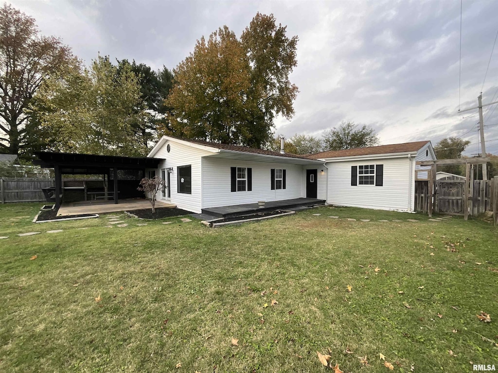 rear view of property with a patio area and a yard