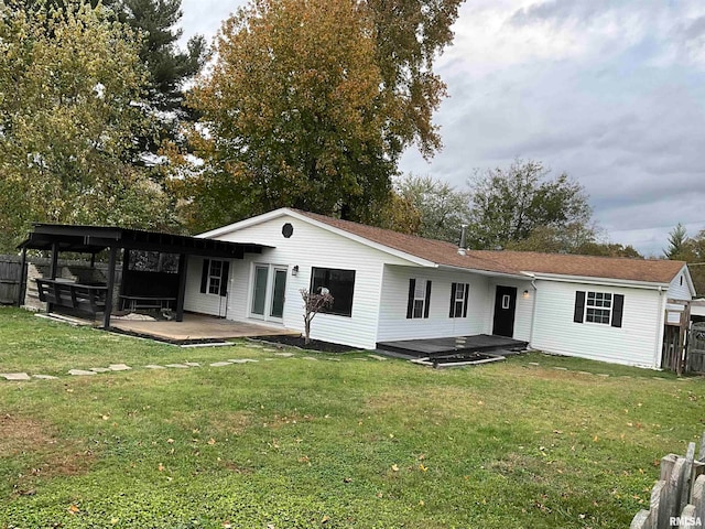 back of property with a yard and a patio area