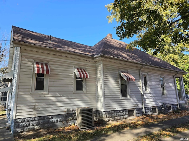 view of side of home featuring central AC unit