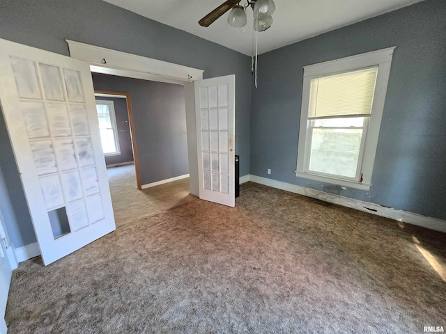 unfurnished bedroom featuring carpet floors and ceiling fan