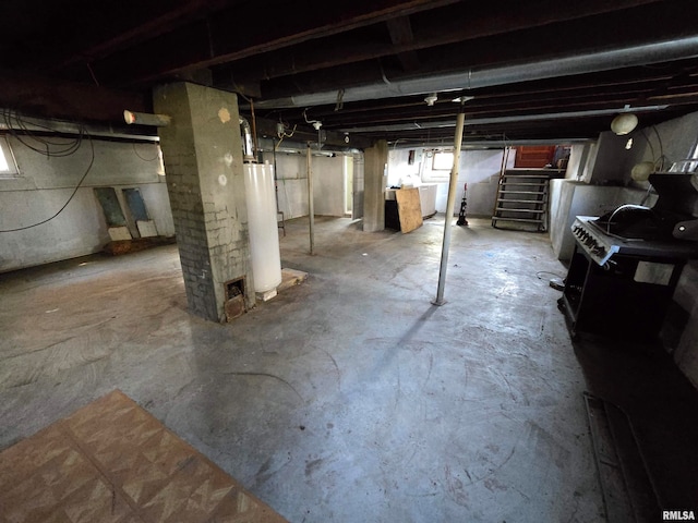 basement with gas water heater and washer / dryer