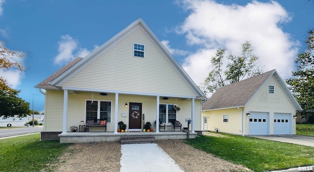 view of front of home with an outbuilding, a garage, and a porch