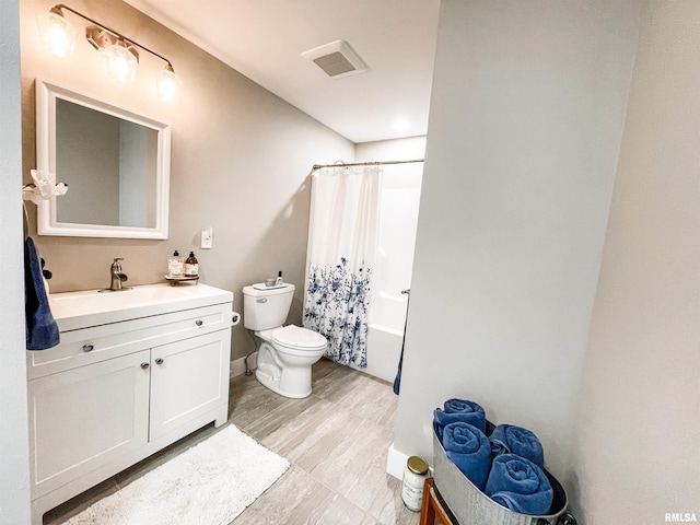 full bathroom with toilet, vanity, and shower / bath combo with shower curtain