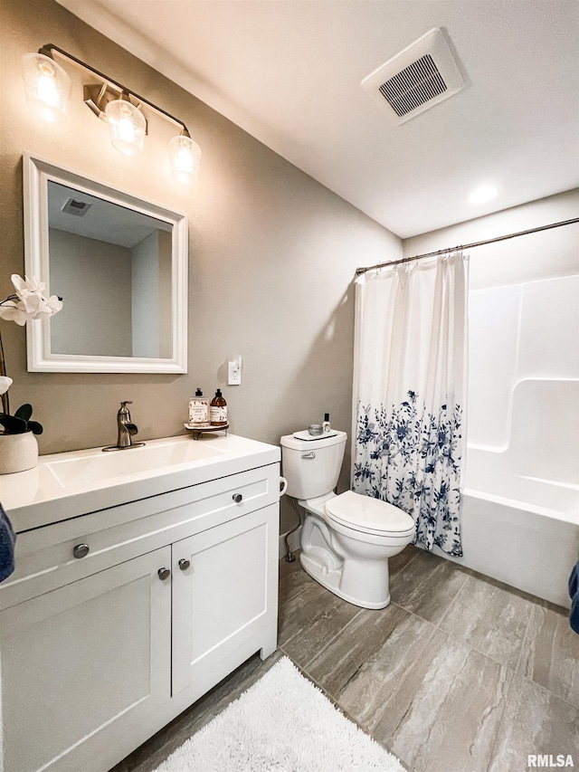 full bathroom with vanity, hardwood / wood-style flooring, toilet, and shower / tub combo