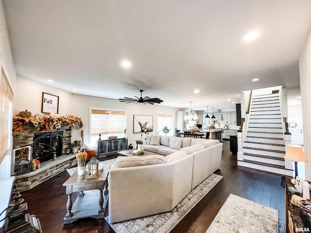 living room featuring a fireplace, ceiling fan, and dark hardwood / wood-style flooring