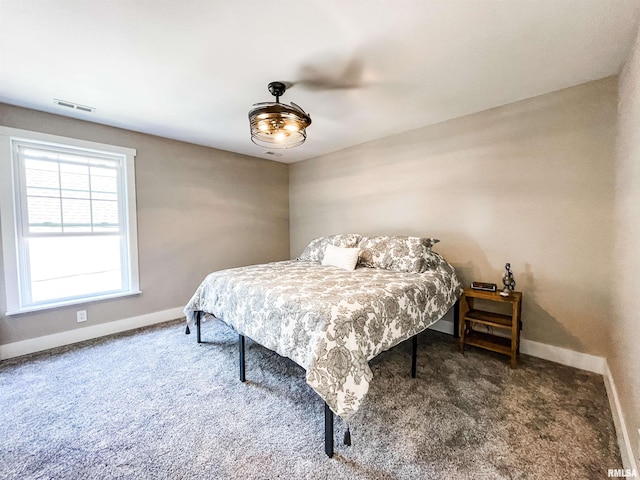 bedroom with dark carpet