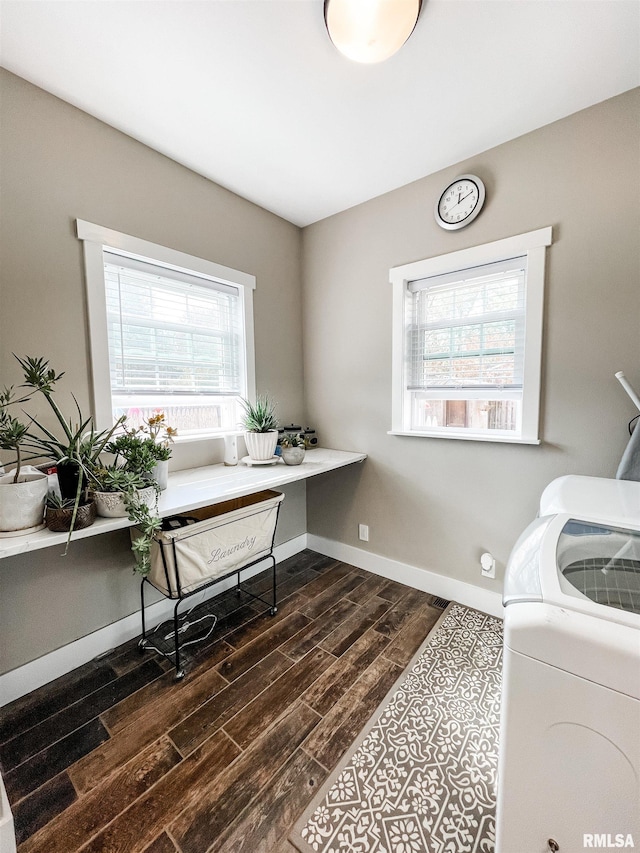 home office featuring dark wood-type flooring and washer / clothes dryer