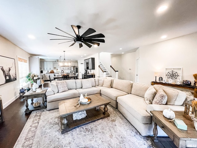 living room featuring wood-type flooring and ceiling fan