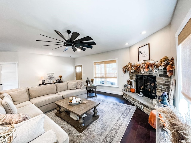 living room featuring a fireplace, hardwood / wood-style flooring, and ceiling fan