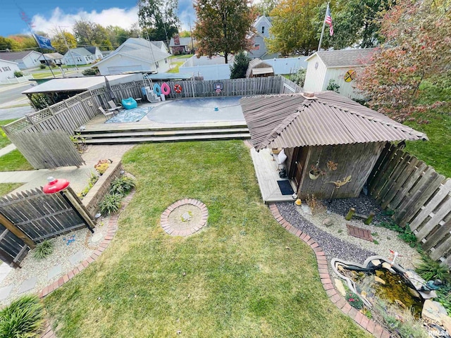 view of yard with a storage shed and a deck