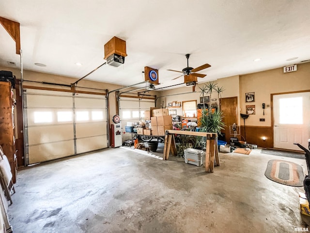 garage featuring ceiling fan and a garage door opener