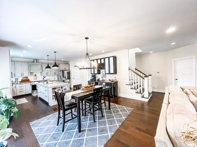 dining area with dark hardwood / wood-style floors and a chandelier