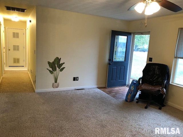 carpeted entrance foyer with ceiling fan