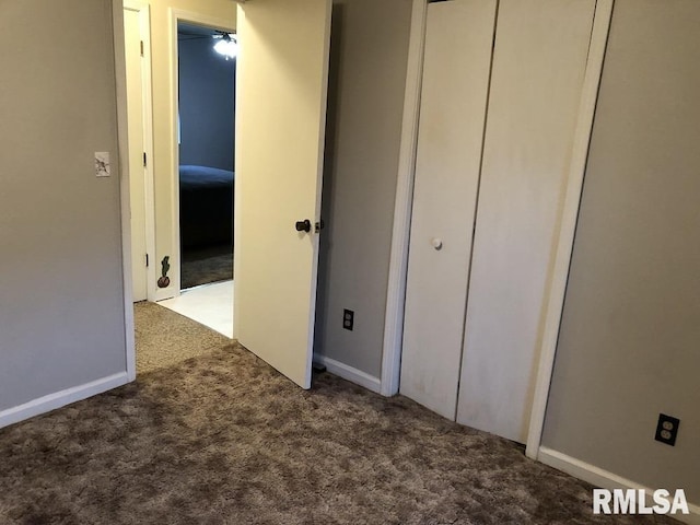 unfurnished bedroom featuring carpet floors and a closet