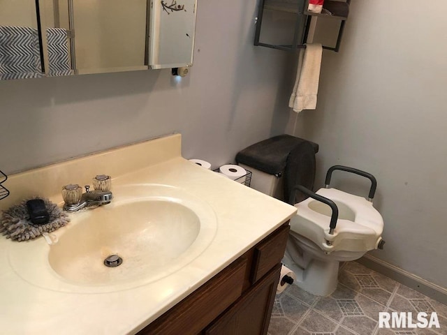 bathroom with toilet and vanity