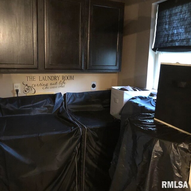 laundry area featuring cabinets