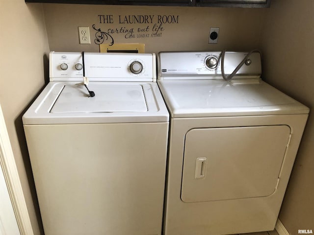 clothes washing area with washing machine and dryer