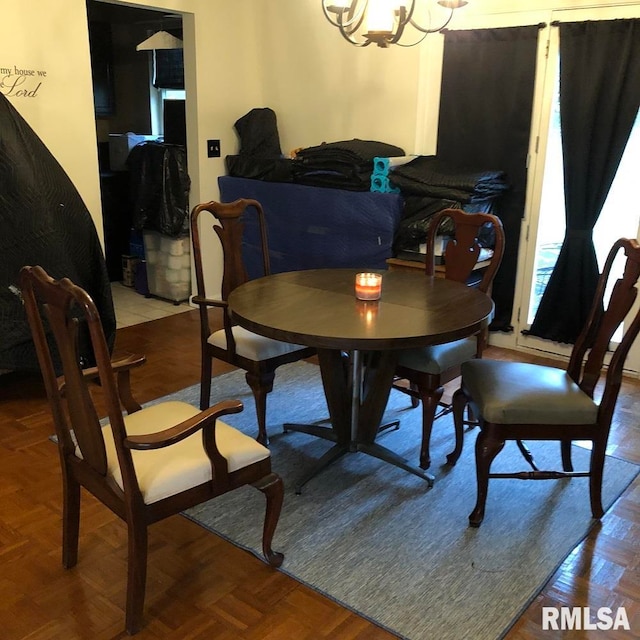 dining space featuring a notable chandelier and parquet floors