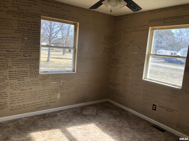 empty room featuring carpet flooring and ceiling fan