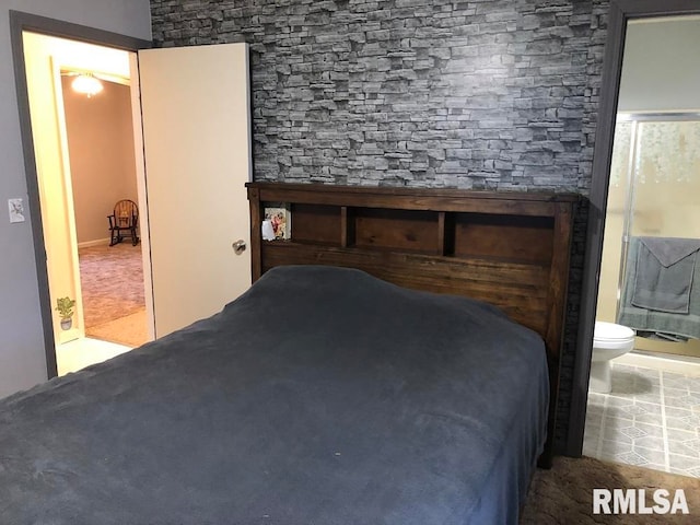 bedroom featuring ensuite bathroom and tile patterned flooring