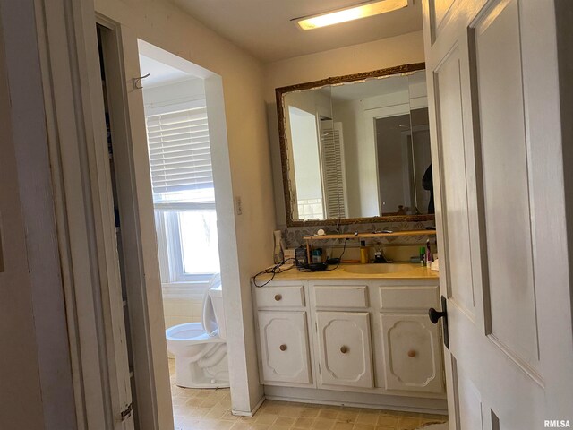 bathroom featuring toilet and vanity