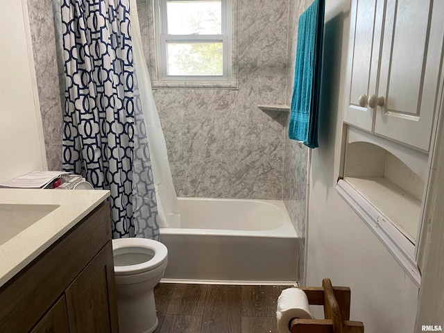 full bathroom featuring wood-type flooring, shower / bath combination with curtain, toilet, and vanity