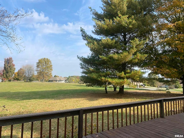 wooden terrace featuring a lawn