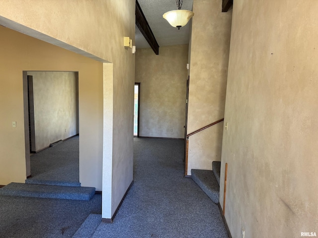 staircase with carpet, a towering ceiling, and beam ceiling