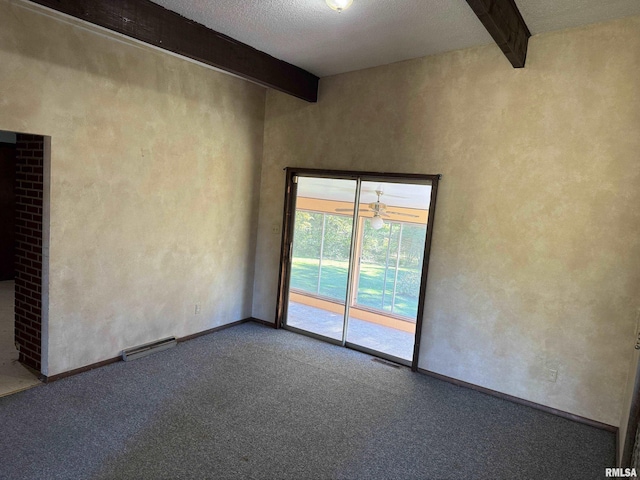 empty room with a textured ceiling, beamed ceiling, and carpet flooring