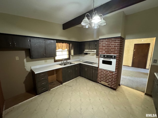 kitchen with sink, black electric cooktop, pendant lighting, beam ceiling, and white oven