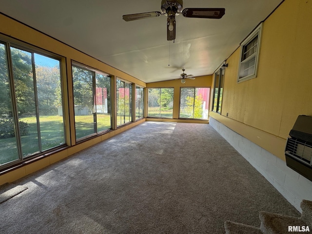 unfurnished sunroom with heating unit and vaulted ceiling