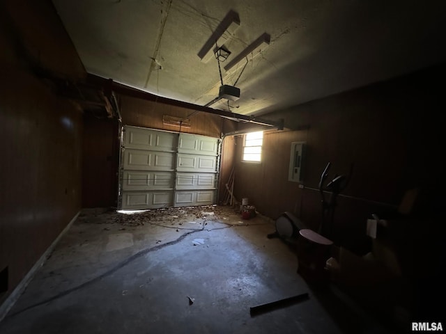 garage featuring a garage door opener and electric panel