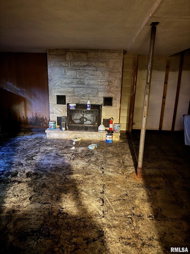 miscellaneous room featuring a stone fireplace