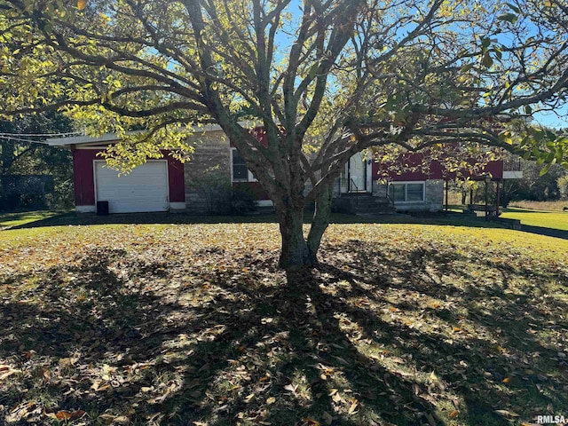 view of front of property with a garage and a front yard