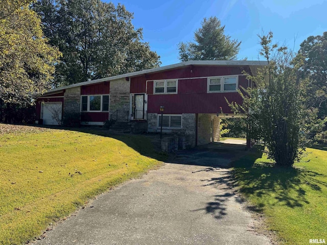 view of front of property with a garage and a front yard