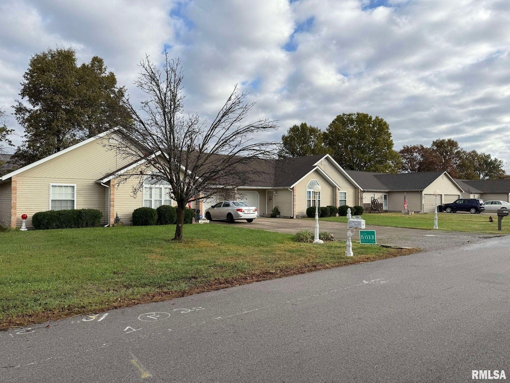 view of front of home with a garage and a front lawn