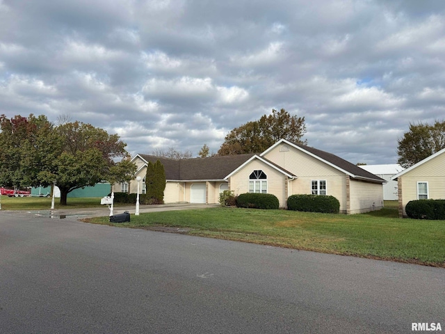 ranch-style house featuring a front lawn and a garage