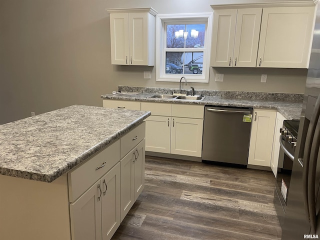 kitchen featuring a kitchen island, appliances with stainless steel finishes, dark wood-style flooring, and a sink