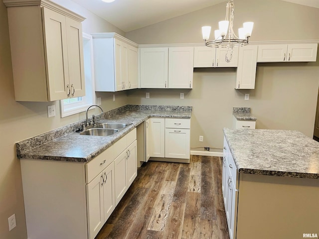 kitchen with dark hardwood / wood-style floors, white cabinetry, sink, and vaulted ceiling